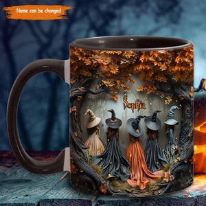 May include: A ceramic mug with a dark brown handle and rim, featuring a Halloween-themed design. The design includes five witches in long dresses and hats, with the name "Sophia" in the center, surrounded by a forest scene with autumn leaves.