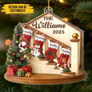 May include: A Christmas ornament shaped like a house with a staircase, featuring four personalized stockings labeled "Daddy," "Mommy," "Buddy," and "Sophia." The ornament includes a Christmas tree and gifts. The text "The Williams 2025" is also visible.