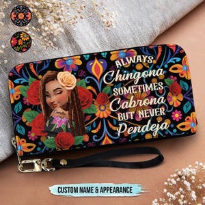 May include: A black wallet with a colorful floral design and the text "ALWAYS Chingona SOMETIMES Cabrona BUT NEVER Pendeja." The wallet features a portrait of a woman and the words "CUSTOM NAME & APPEARANCE."