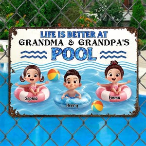 May include: A rectangular metal sign with the text "LIFE IS BETTER AT GRANDMA & GRANDPA'S POOL". The sign features cartoon children in inner tubes in a pool with beach balls. The children's names are Sophia, Henry, and Emma.
