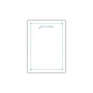 May include: A white notepad with a light blue border and the name "Julie Watkins" written in cursive at the top.
