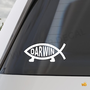 May include: White vinyl decal featuring a stylized fish shape with the word "DARWIN" in the center. The decal is designed to be applied to a car window or similar surface. The design is simple and modern.