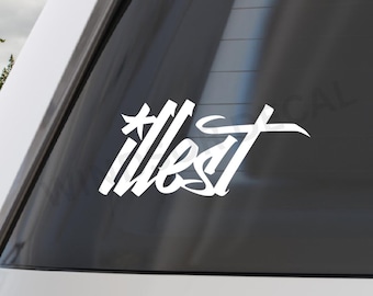 May include: White vinyl decal featuring the word "illest" in a distinctive script font. The decal is affixed to a car window, with the word presented in a bold, striking design. This is a car accessory.