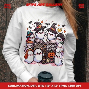 May include: White sweatshirt featuring a colorful Halloween-themed graphic. The design includes cute ghosts, witch hats, bats, hearts, and a pumpkin. The text "Spooky Book Club" is visible on an open book. The sweatshirt is 15" x 13".