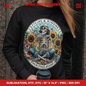 May include: Black sweatshirt featuring a circular design with a skeleton wearing a hat, holding a coffee, and surrounded by sunflowers and flowers. The design includes the text "CAFFEINE & KINDNESS" and "BREW-TIFUL BLEND".
