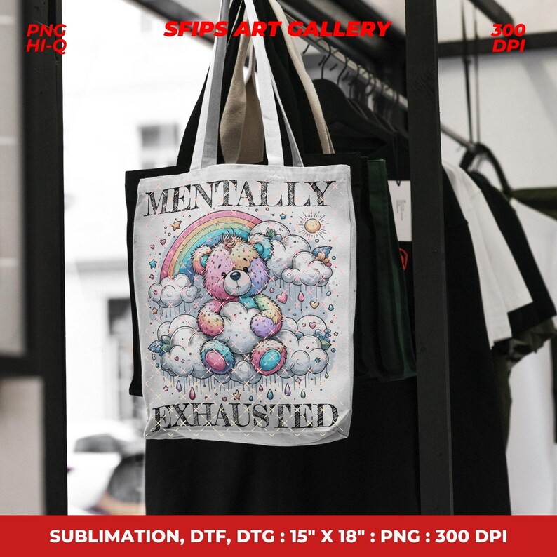 May include: White tote bag featuring a colorful illustration of a teddy bear sitting on clouds under a rainbow. The text "MENTALLY EXHAUSTED" is printed below the bear. The bag measures 15" x 18".