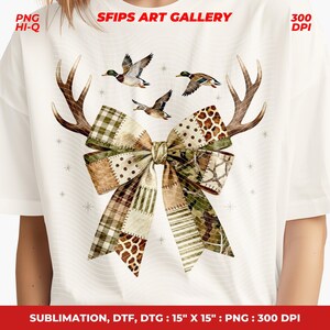 May include: White t-shirt with a bow design in brown, green, and tan patchwork. The bow is decorated with deer antlers and flying ducks. The text "SFIPS ART GALLERY" is at the top. The design is 38 cm x 38 cm.