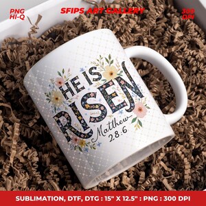 May include: White ceramic mug with the text "HE IS RISEN" and "Matthew 28:6" in black script. The mug is decorated with floral designs in pastel colors. The mug is in a box with brown paper filler.