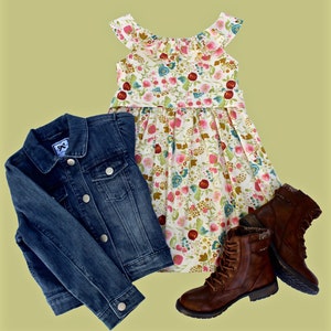 May include: A denim jacket, floral dress, and brown leather boots are displayed on a light green background. The dress has a white base with a colorful floral pattern. The boots have laces and a textured design.