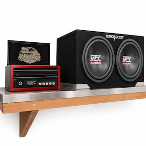 May include: A red audio amplifier with a black control panel and a logo reading CarGuys Paradise Shop, positioned next to a black dual-subwoofer enclosure labeled MTX Audio and Terminator. The amplifier features a digital display and knobs.