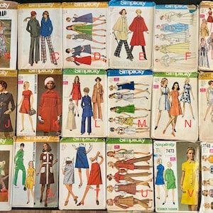 May include: A collection of vintage Simplicity sewing pattern envelopes. The covers feature illustrations of women in various outfits, including dresses, coats, and pantsuits. The patterns are from the 1960s and 1970s, with a retro aesthetic.