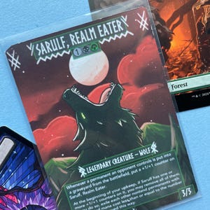 K&ouml;nnte beinhalten: Eine Magic: The Gathering-Karte mit einem heulenden Wolf unter einem Vollmond. Die Karte tr&auml;gt den Titel "Sarulf, Realm Eater" und enth&auml;lt Spieltext. Das Kunstwerk ist vor einem roten Himmel mit gr&uuml;nen Akzenten platziert. Die Karte ist 3/3.