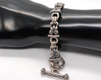 Pulsera vintage mexicana de plata de ley 925 con eslabones en espiral y cierre de palanca decorativo.