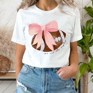 Kundenspezifisches Maskottchen-Bogen-Shirt, Ball und Bogen-Shirt, niedliches Fußball-Shirt, Beifall-Maskott-T-Stück Fußball-Mannschaft Jersey-Kokette Bögen Schulgeist-T-Shirt