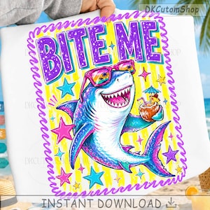 May include: A white graphic featuring a cartoon shark wearing sunglasses and holding a tropical drink. The shark is blue, pink, and purple, with the words "BITE ME" in large letters above it. The background is yellow with stars.