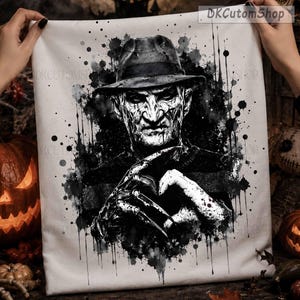 May include: A white fabric square featuring a black and white ink-splatter style illustration of a man in a fedora hat with a scarred face and a bladed glove. The design includes the text DKCutomShop in the top right corner.
