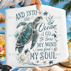 Puede incluir: Camiseta blanca con una ilustración de tortuga marina turquesa y el texto "AND INTO the Ocean I GO to lose MY MIND and find MY SOUL." El diseño incluye estrellas de mar, conchas y tortugas más pequeñas.