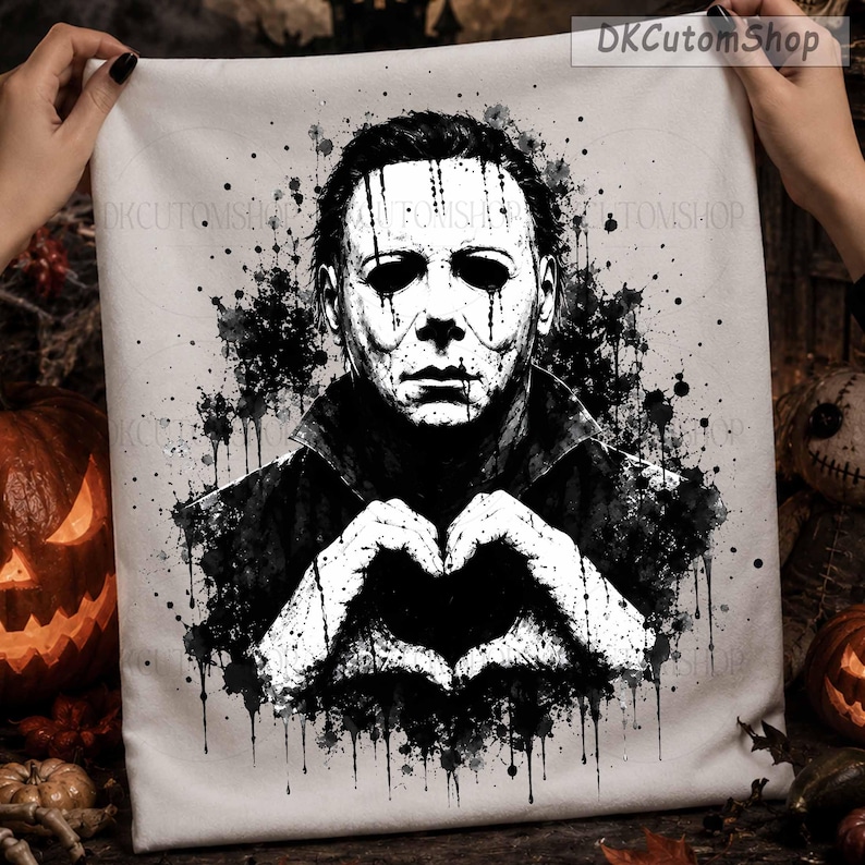 May include: A white fabric square featuring a black ink-style illustration of a masked character with dark eyes and dripping paint effects. The character is forming a heart shape with their hands. The text DKCutomShop appears in the corner.