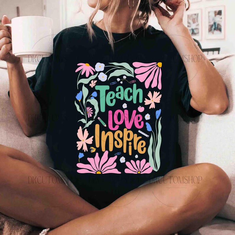 May include: Black t-shirt with a colorful floral design and the text "Teach Love Inspire".