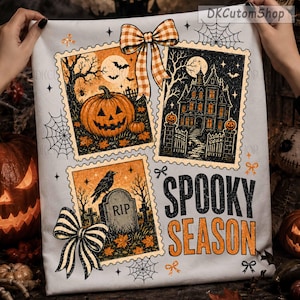 May include: A white fabric featuring three postage stamp-style illustrations with Halloween themes: a jack-o'-lantern, a haunted house, and a tombstone with a raven. The design includes orange and black bows, spiderwebs, and the text SPOOKY SEASON.