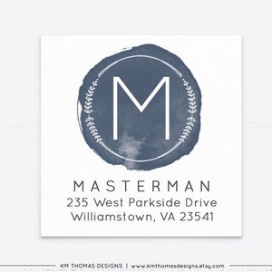 May include: A blue watercolor monogram return address label with the letter "M" in a white circle surrounded by a wreath of leaves. The text "MASTERMAN", "235 West Parkside Drive", and "Williamstown, VA 23541" is printed below the monogram.