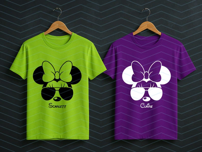 May include: Two short-sleeved t-shirts, one lime green and one purple, each featuring a cartoon mouse face with sunglasses and a bow. The green shirt has the name "Scarlett" and the purple shirt has the name "Claire" printed below the face.