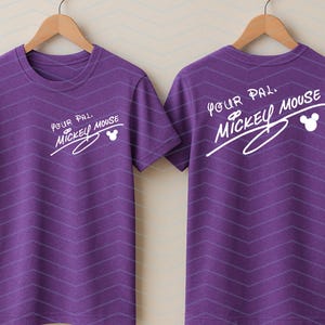 May include: A purple short-sleeved t-shirt featuring a subtle chevron pattern and white text on the front and back that reads Your Pal Mickey Mouse, accompanied by a small white Mickey Mouse head silhouette icon.