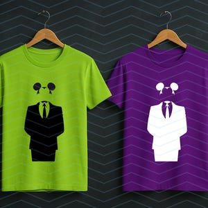 May include: A lime green t-shirt and a purple t-shirt, each featuring a graphic print of a suit jacket, a necktie, and a pair of circular ears. The lime green shirt displays the graphic in black, while the purple shirt displays the graphic in white.