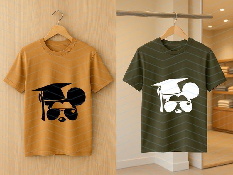 May include: Two short-sleeved t-shirts, one mustard yellow and one olive green, each featuring a graphic of a mouse wearing a graduation cap and sunglasses. The mouse design is black on the yellow shirt and white on the green shirt.