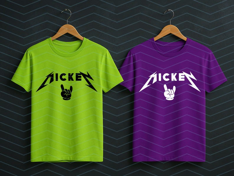May include: Two t-shirts, one lime green and one purple, each with the word "MICKEY" in a stylized font with lightning bolt accents. Below the word is a hand gesture. The shirts are hanging on wooden hangers.