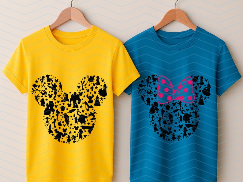 May include: A yellow t-shirt and a blue t-shirt, both featuring a black silhouette of a mouse head shape filled with various character figures. The blue t-shirt includes a pink polka-dot bow graphic positioned above the mouse head silhouette.
