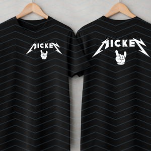 May include: Black short-sleeve t-shirts with a white graphic design. The design features the word "MICKE" in a stylized font with a hand making a rock and roll gesture. The shirts are displayed on wooden hangers.