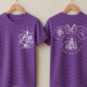 May include: Purple t-shirt with a white Minnie Mouse graphic on the front and a matching design on the back. The back design includes the text "The Happiest Place on Earth" and a castle illustration.