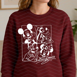 May include: A maroon crewneck sweatshirt featuring a white graphic print divided into four square panels. The design displays line art illustrations of Mickey Mouse, Goofy, Pluto, and Minnie Mouse, with the text Mickey Mouse written below.