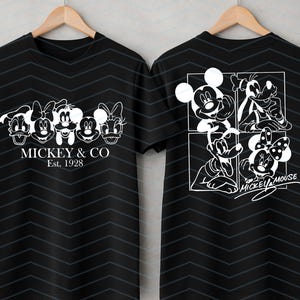 May include: A black short-sleeve t-shirt with a subtle dark chevron pattern. The front features white line art of five cartoon characters and the text MICKEY & CO Est. 1928. The back displays a four-panel grid of characters and the text MICKEY MOUSE.