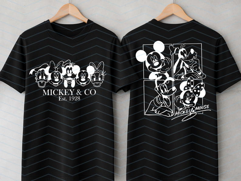 May include: A black short-sleeve t-shirt with a subtle dark chevron pattern. The front features white line art of five cartoon characters and the text MICKEY & CO Est. 1928. The back displays a four-panel grid of characters and the text MICKEY MOUSE.