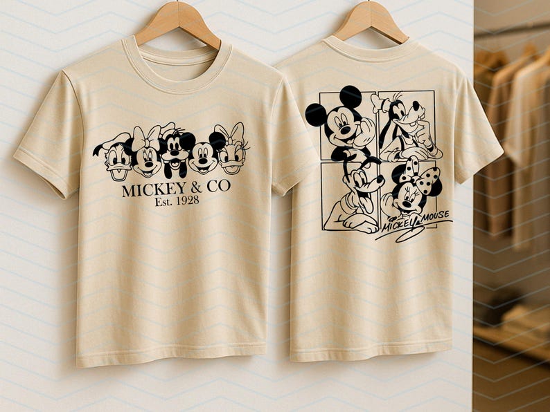 May include: A beige t-shirt featuring a black graphic print of Disney characters on the front and back. The front displays five character faces with the text MICKEY & CO Est. 1928. The back shows four characters in a grid with the text MICKEY MOUSE.