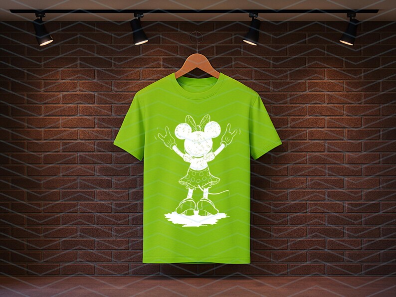 May include: A lime green t-shirt with a white cartoon character graphic, bow, hands raised, and a polka dot skirt. The shirt hangs on a wooden hanger against a brick wall.