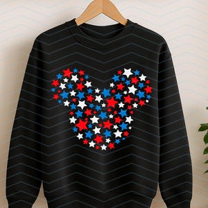 May include: A black long-sleeve sweatshirt featuring a central graphic composed of numerous small red, white, and blue stars arranged to form the distinct silhouette of a mouse head with two rounded ears and a circular face shape.