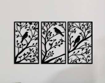 May include: Three black metal wall art pieces featuring a silhouette of birds on branches. The pieces are arranged in a row and are mounted on a white wall.