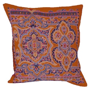 May include: Orange cushion with a colourful embroidered design featuring intricate patterns and sequins.