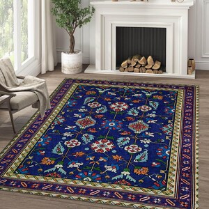 May include: A blue and cream patterned rug with a floral design. The rug has a dark blue border with a geometric pattern.