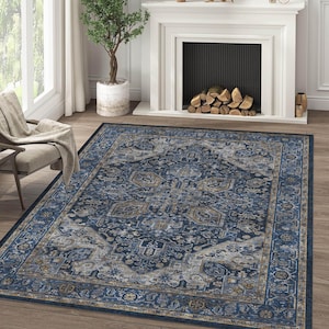 May include: A large, rectangular rug with an ornate, traditional design. The rug features a navy blue central field with intricate patterns in shades of grey, beige, and gold. A dark blue border frames the design, creating a classic look.