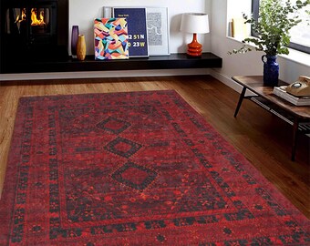 May include: A red rug with a black and red patterned design. The rug has a traditional Persian style with intricate details.