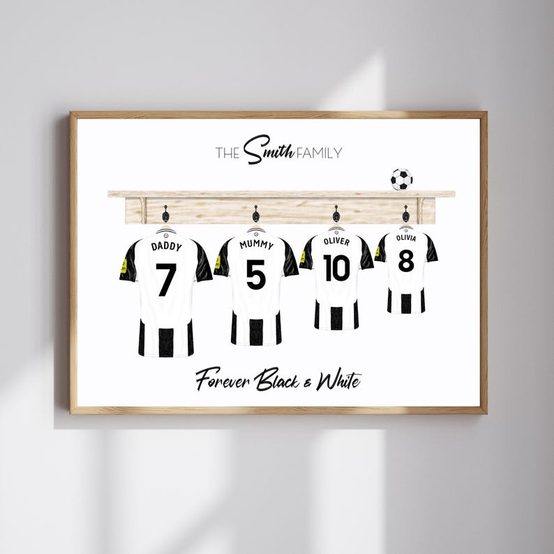 May include: A framed print featuring four black and white soccer jerseys hanging on a wooden rack. Each jersey has a name and number: Daddy 7, Mummy 5, Oliver 10, and Olivia 8. The text "The Smith Family" and "Forever Black & White" are also displayed.