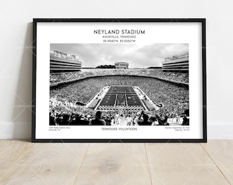May include: A black and white framed print of Neyland Stadium in Knoxville, Tennessee. The text reads: NEYLAND STADIUM, KNOXVILLE, TENNESSEE, 35.9540°N 83.9250°W, 1235 Philip Fulmer Way, Knoxville, TN, TENNESSEE VOLUNTEERS, Opened: September 24, 1921, Capacity: 101,915.