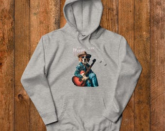May include: Grey hooded sweatshirt featuring a graphic of a dog wearing a cowboy hat and playing a guitar. The text "The Howler" is printed above the dog.