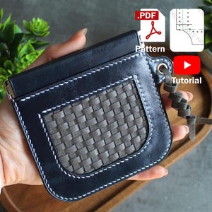 May include: A black leather wallet with a woven gray panel and white stitching. The wallet has a flap closure and a leather strap. The image includes icons for a PDF pattern and a tutorial.