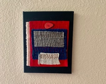 Textile Art Handsewing with Red Button on Black Canvas