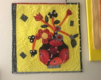 Fiber Art Wall Hanging with appliqued flowers and yellow background